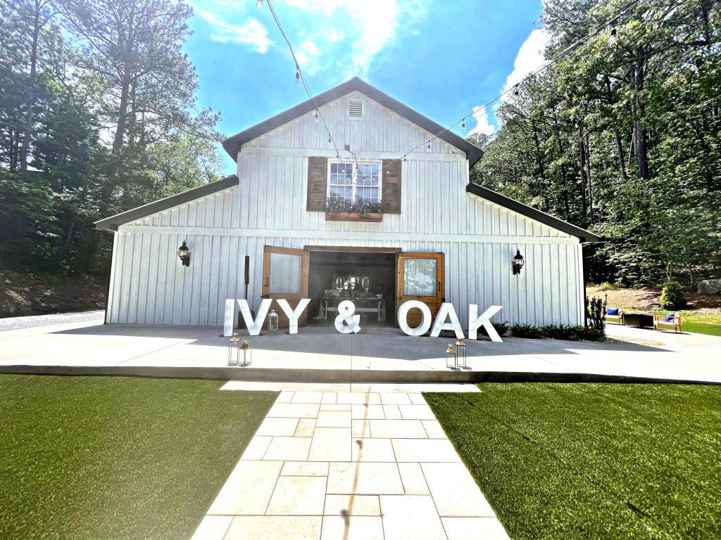 Wedding barn at Ivy and Oak wedding venue with big letter signs spelling "IVY & OAK"